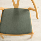 Dining seat upholstered in Loden Fabric, Sage by Tonic Living — durable high-performance sage green upholstery fabric.