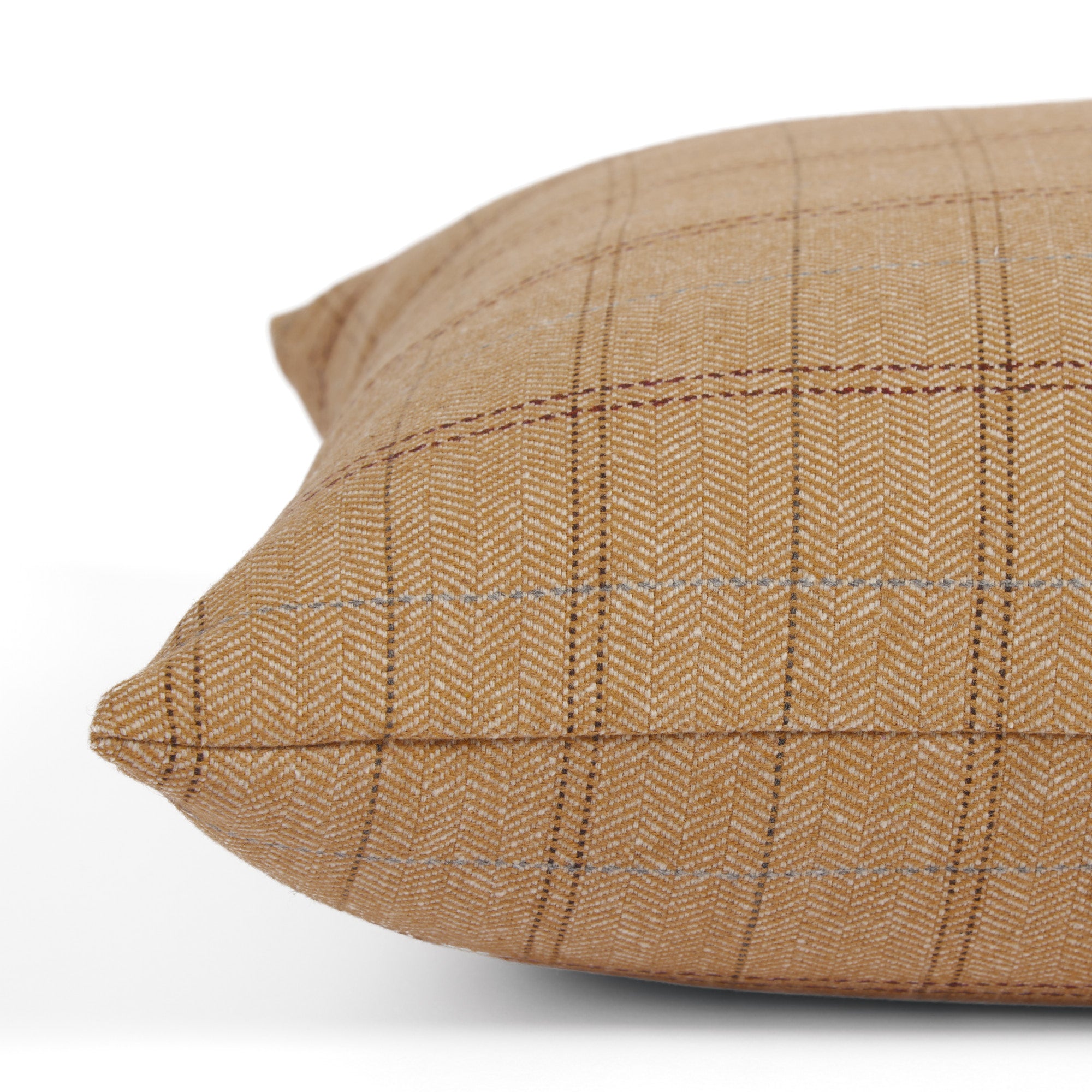Side view of Tonic Living Lundie Plaid decorative pillow highlighting its herringbone texture and warm camel tones.