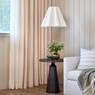 Lyra Fabric, Blush by Tonic Living — linen-blend drapery fabric with a white and light pink floral block print, shown in a living room with a Briar Stripe 20x20 Pillow, Wheat.