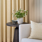 Lyra 14x20 Lumbar Pillow, Butter Yellow by Tonic Living styled on a chair with matching Lyra Butter Yellow floral block print drapery.