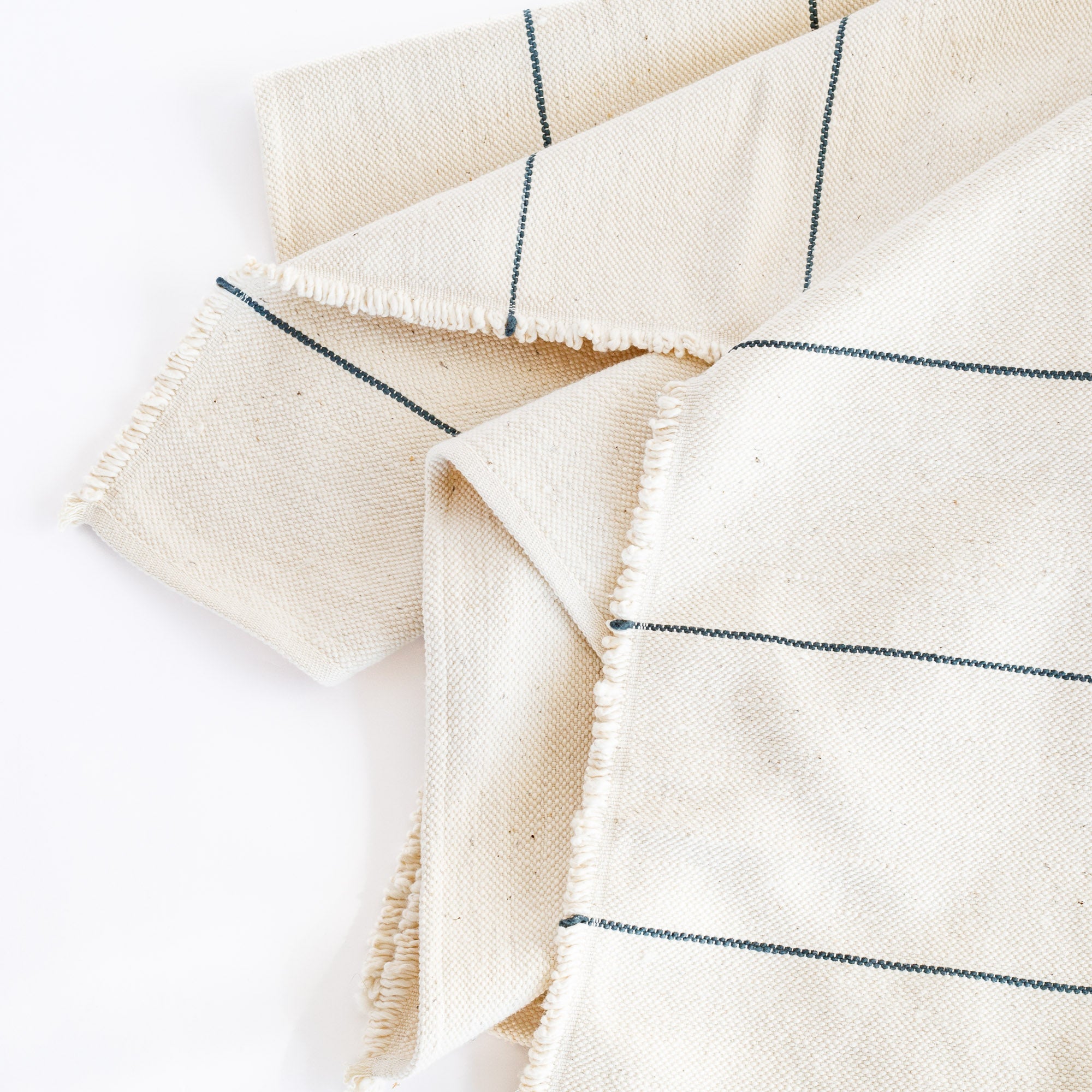 a cream and navy stripe cotton hand loomed throw blanket with fringe: view 3