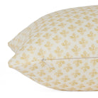 Side zipper detail of Lyra 14x20 Butter Yellow lumbar pillow by Tonic Living — white and yellow printed linen-blend fabric.