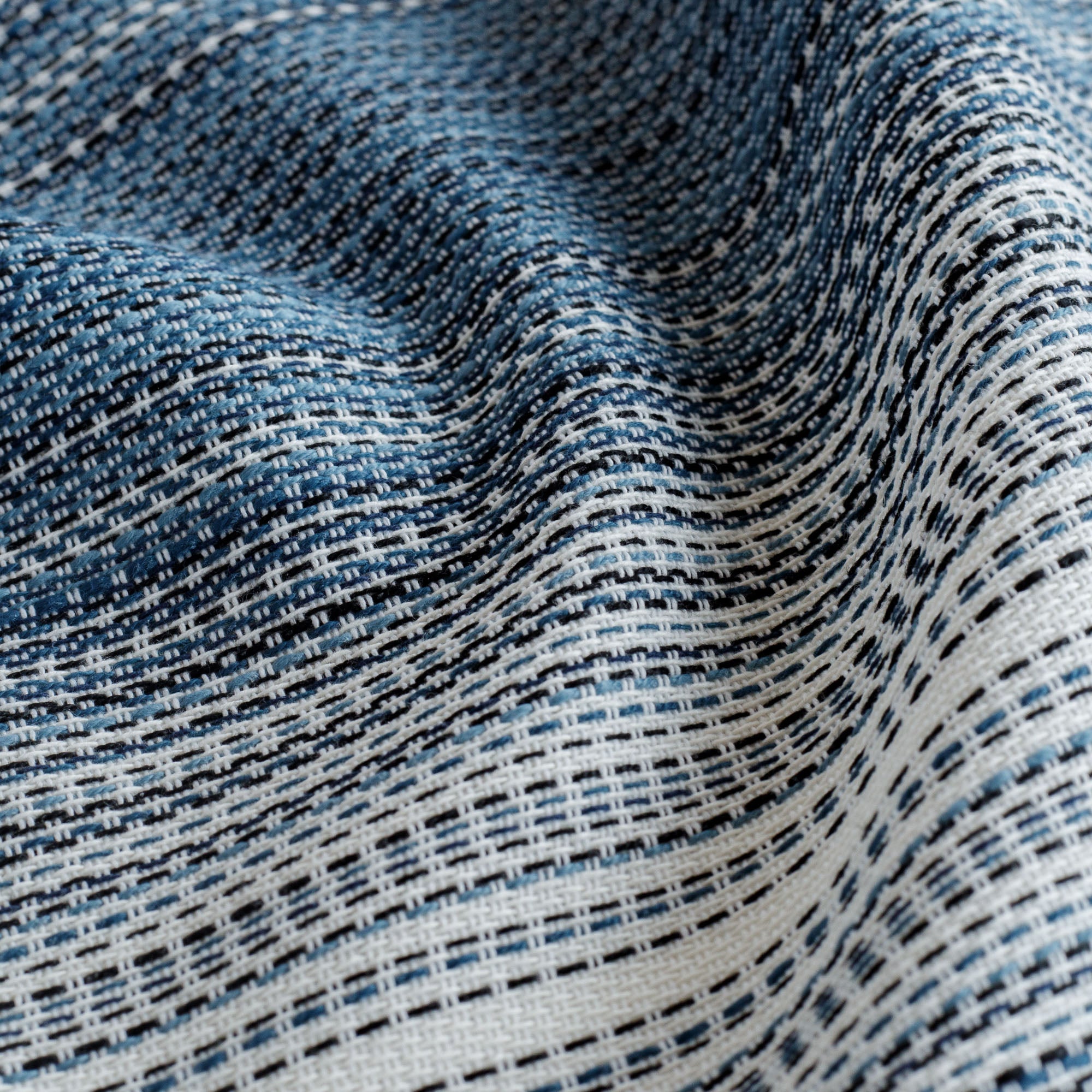 a blue and white stripe upholstery fabric : close up view