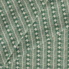 Tonic Living Meadow Fabric in Emerald showcasing a graphic spruce green and white pattern.