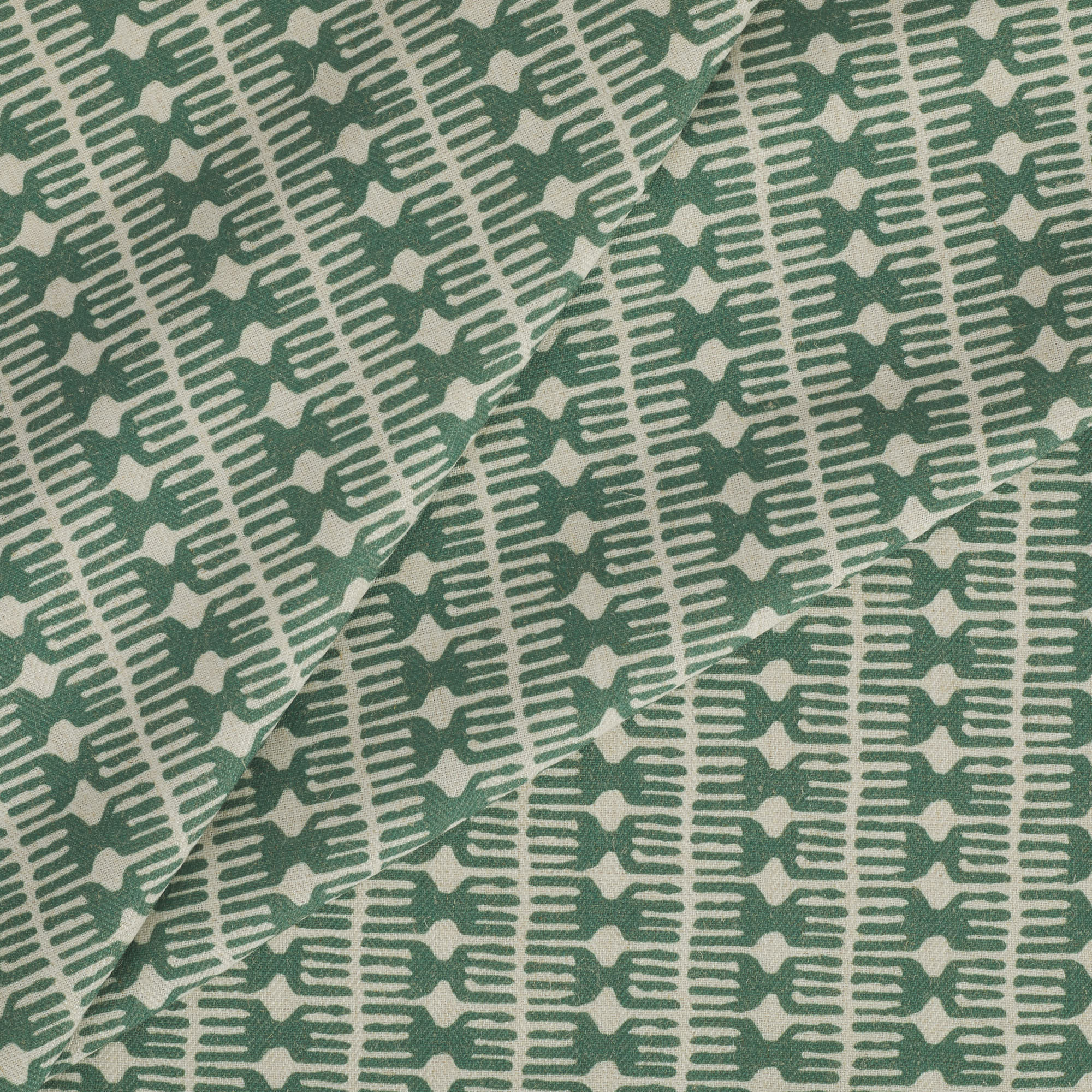 Tonic Living Meadow Fabric in Emerald showcasing a graphic spruce green and white pattern.