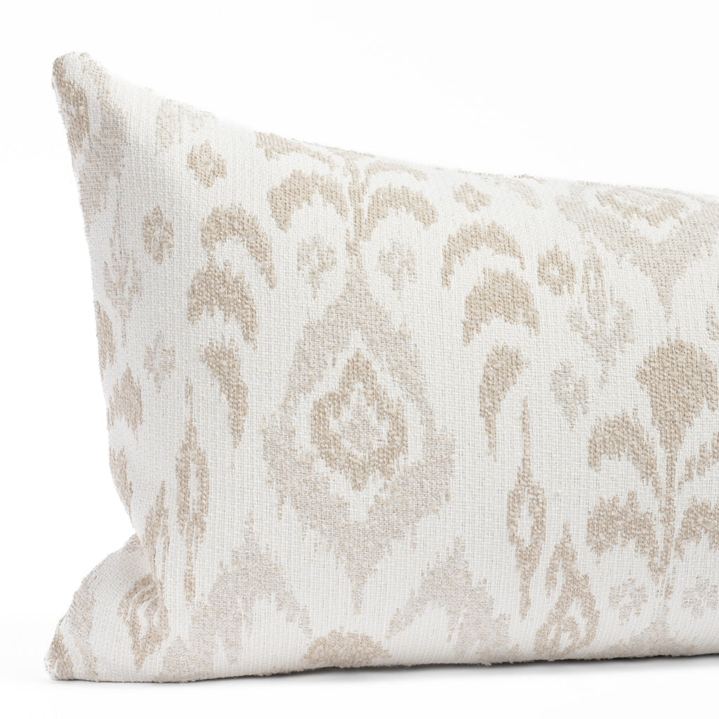 a white, cream and taupe large scale ikat patterned, chenille textured bolster pillow : close up view