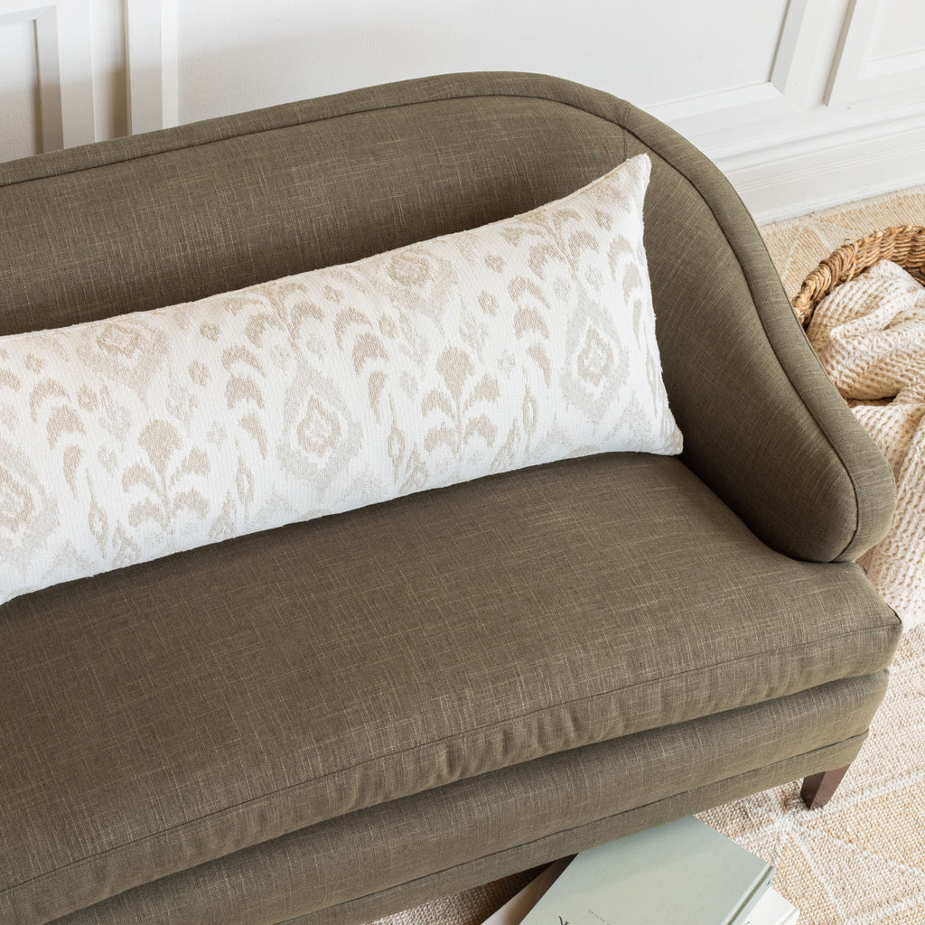 Tonic Living home decor: Monterey white, cream and taupe large scale ikat patterned, chenille textured bolster pillow on Hollis Moss fabric upholstered sofa