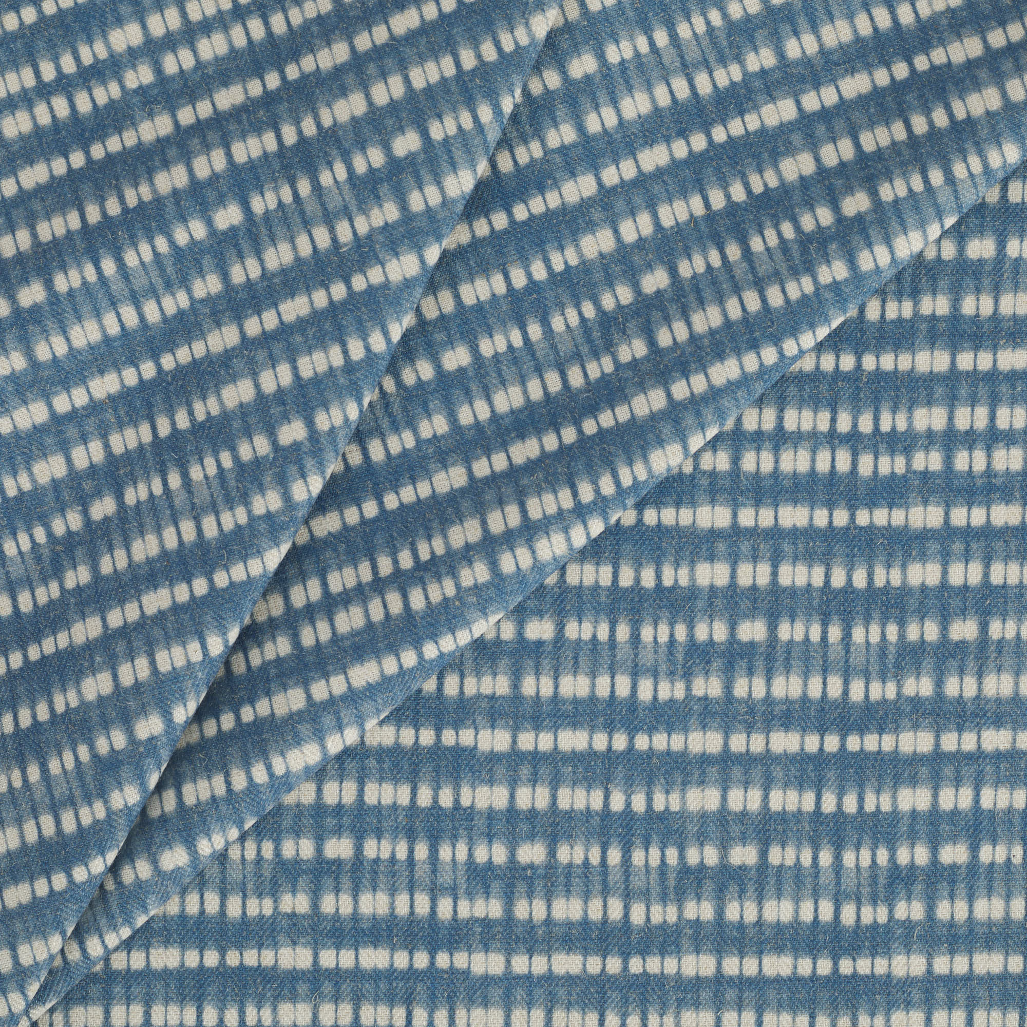 Tonic Living Nile Indigo home decor fabric with a modern coastal dotted stripe pattern.