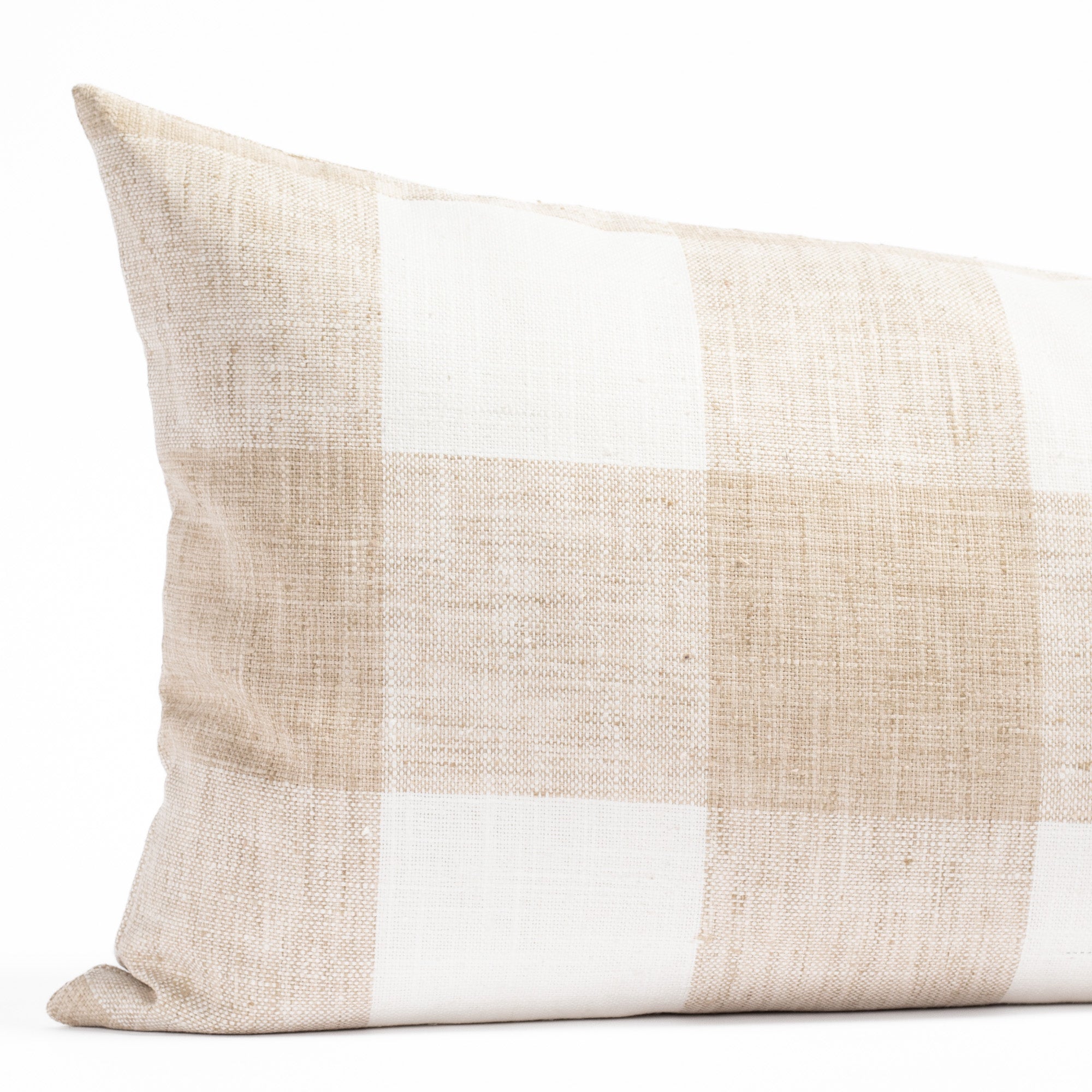 a soft white and sandy beige buffalo check patterned bed bolster pillow from Tonic Living : close up view