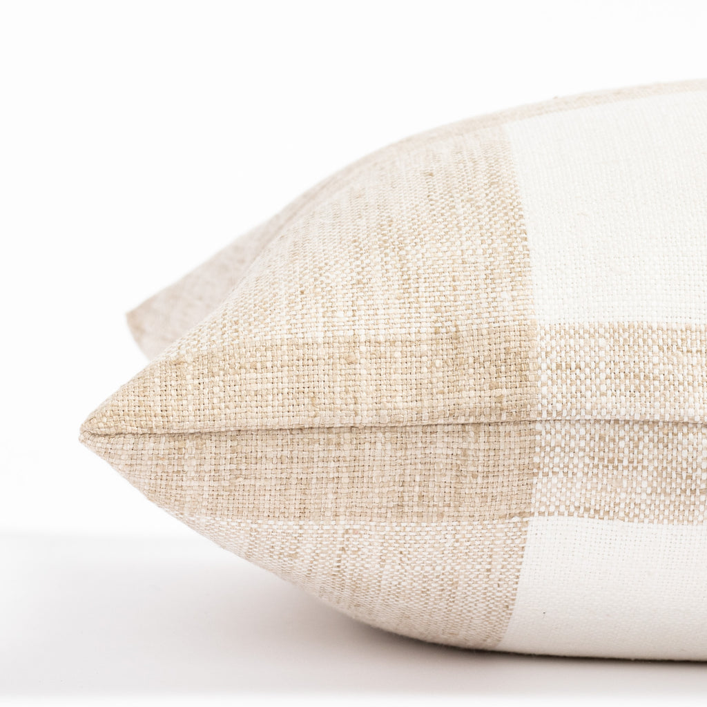 a soft white and sandy beige check patterned pillow : close up side view