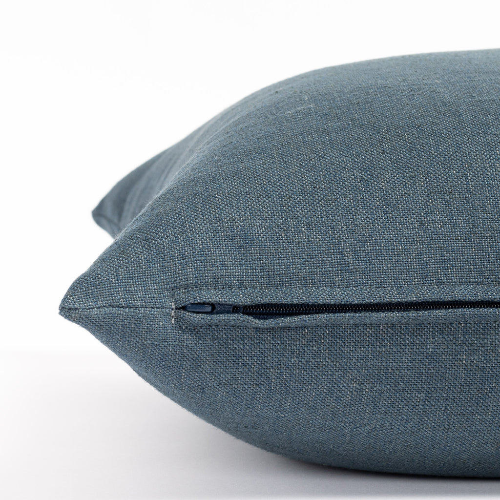 an indigo solid blue throw pillow: close up zipper view