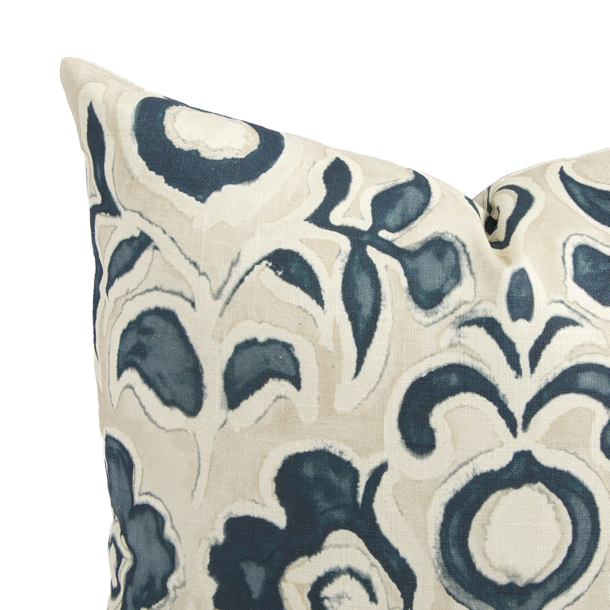 Close up of Tonic Living Paloma Ink pillow showing painterly navy blue flowers and scrolling leaves on oatmeal beige.