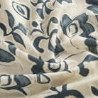 Tonic Living Paloma Ink drapery fabric featuring bold inky blue blooms and scrolling leaves on a neutral oatmeal background.