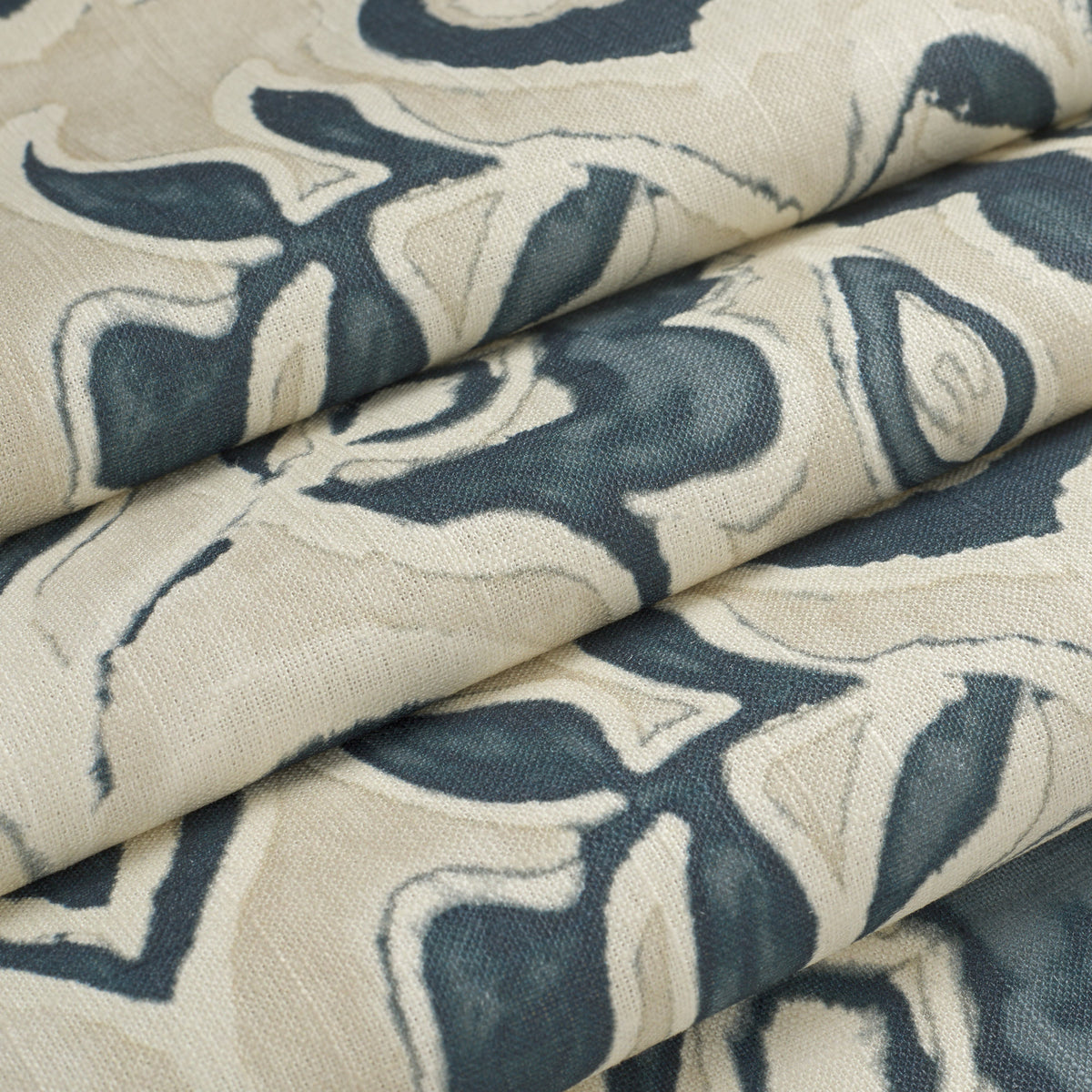 Tonic Living Paloma Ink floral fabric shown as a Roman shade, featuring a stylized navy blue botanical pattern on oatmeal beige.