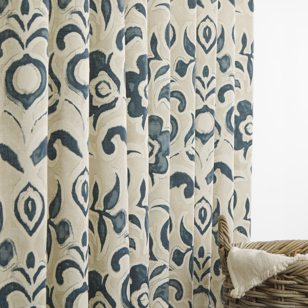Tonic Living Paloma Ink floral drapery fabric shown as curtains featuring a painterly navy blue botanical pattern on oatmeal beige.