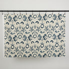 Full yard of Tonic Living Paloma Fabric in Ink hanging to show the scale and drape of its navy blue floral pattern.
