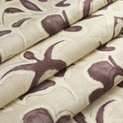 Tonic Living Paloma Mauve floral fabric shown as a Roman shade, featuring a stylized smoky plum botanical pattern on oatmeal beige.