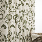 Tonic Living Paloma Olive floral drapery fabric shown as curtains featuring a painterly earthy green botanical pattern on oatmeal beige.