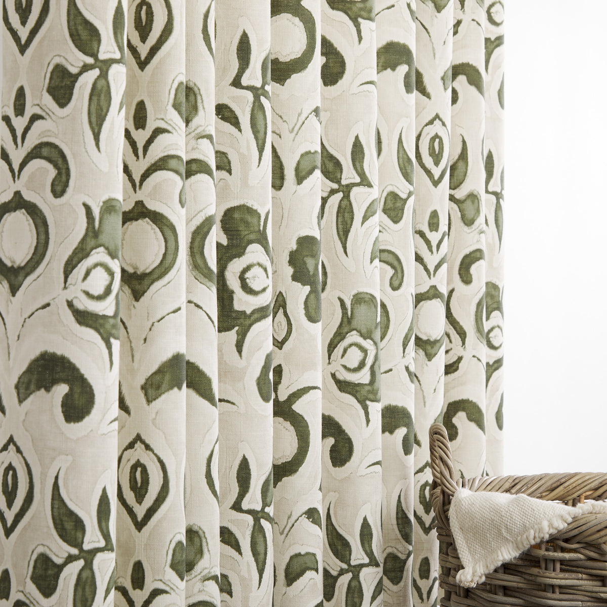 Tonic Living Paloma Olive floral drapery fabric shown as curtains featuring a painterly earthy green botanical pattern on oatmeal beige.