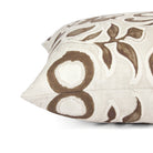 Side view of Tonic Living Paloma Walnut toss cushion highlighting its stylized brown floral pattern and soft neutral palette.
