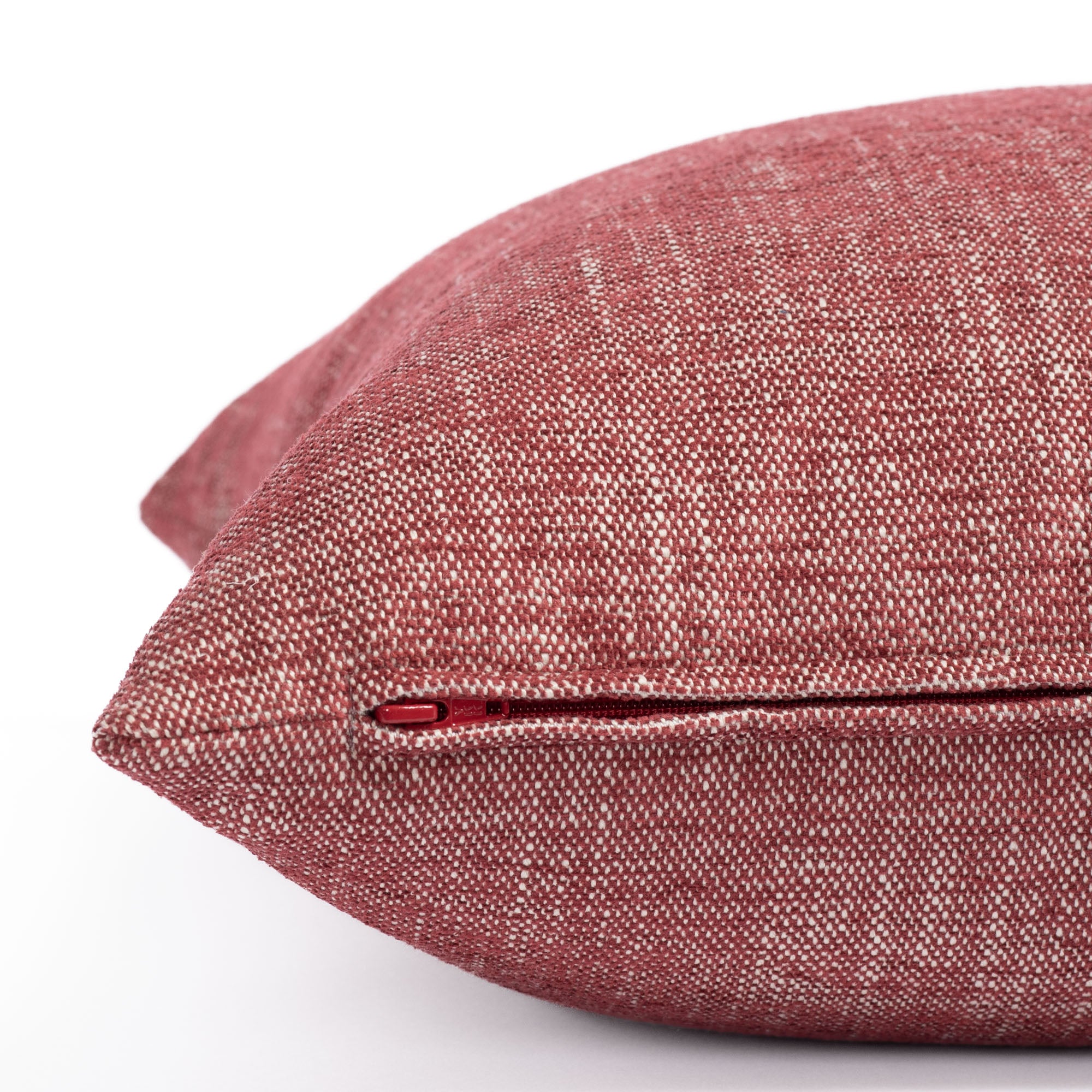 a ruby red chenille textured outdoor pillow : close up zipper view