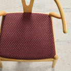 Dining chair upholstered in Pembrook Fabric Merlot, a burgundy home decor fabric with geometric diamond design from Tonic Living.