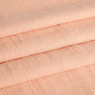 Tonic Living Pietra Salmon Pink linen fabric shown as Roman blinds with a soft woven texture and relaxed look.