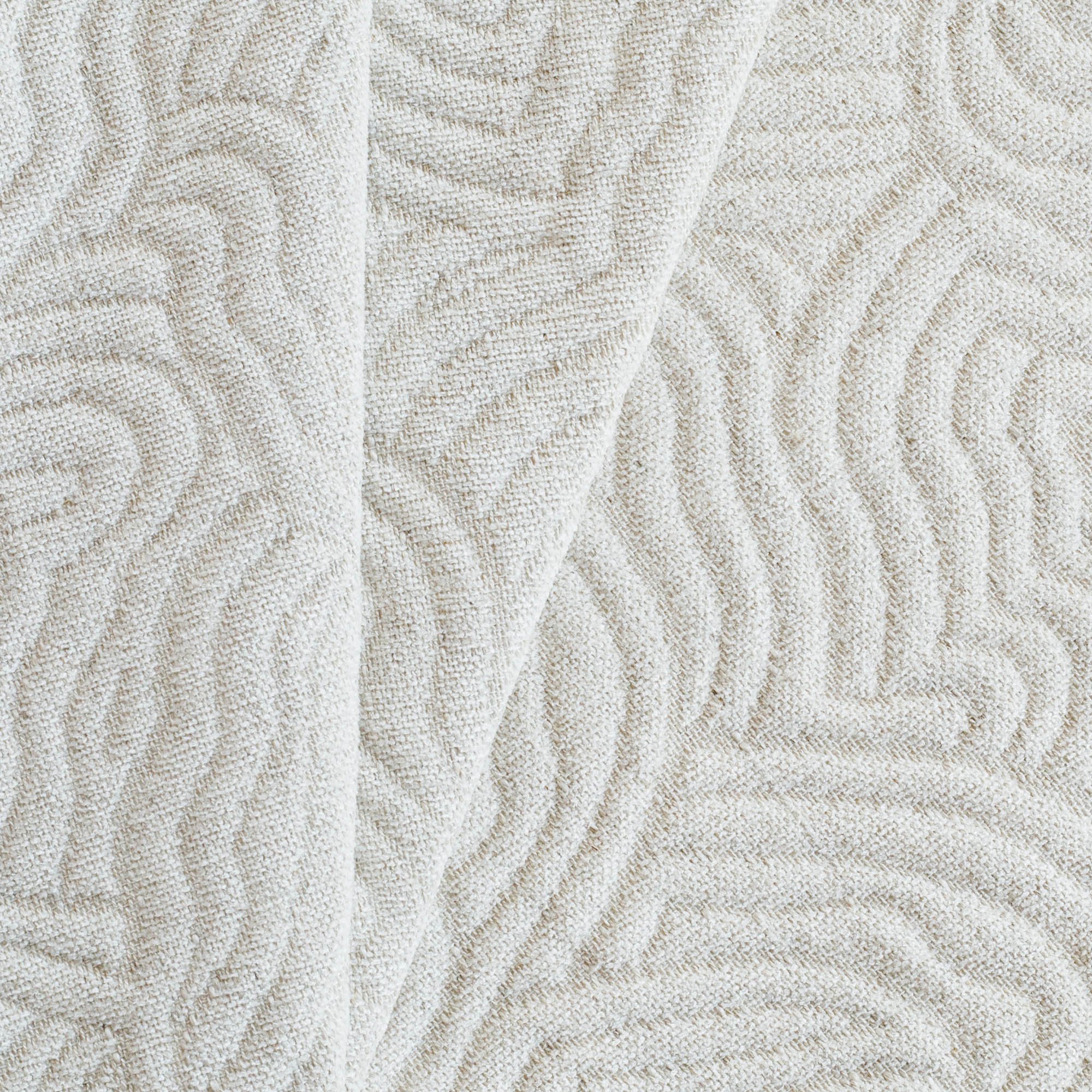 a soft cream and beige quilted abstract wave patterned fabric