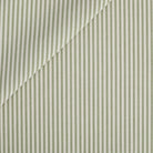 This green and white striped outdoor upholstery fabric features a timeless, narrow stripe with a clean, tailored look. Its classic ticking stripe