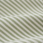 Close up of Tonic Living Refresh Sunbrella Hedge fabric showing green and white ticking stripe detail.