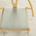 Tonic Living Refresh Sunbrella Hedge outdoor upholstery fabric on a dining chair seat in green and white stripe.