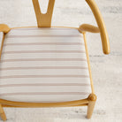 Dining chair upholstered in Tonic Living Rexton Stripe Fabric, Merlot — durable high-performance upholstery fabric in burgundy and oatmeal stripes.