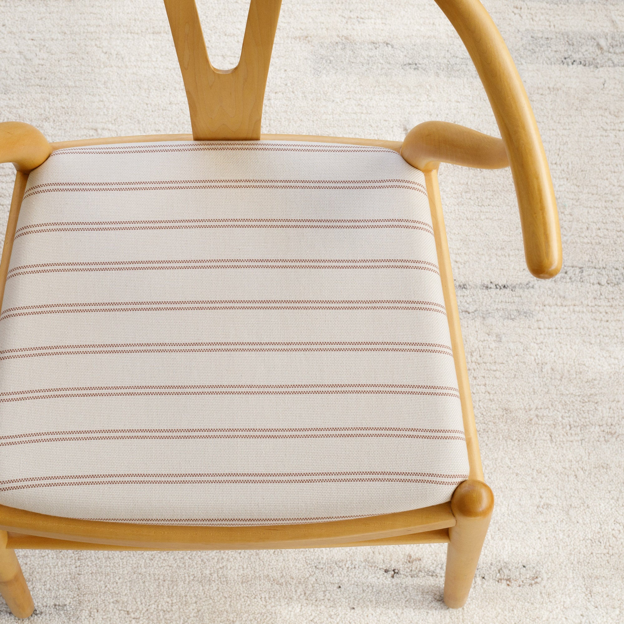Dining chair upholstered in Tonic Living Rexton Stripe Fabric, Merlot — durable high-performance upholstery fabric in burgundy and oatmeal stripes.