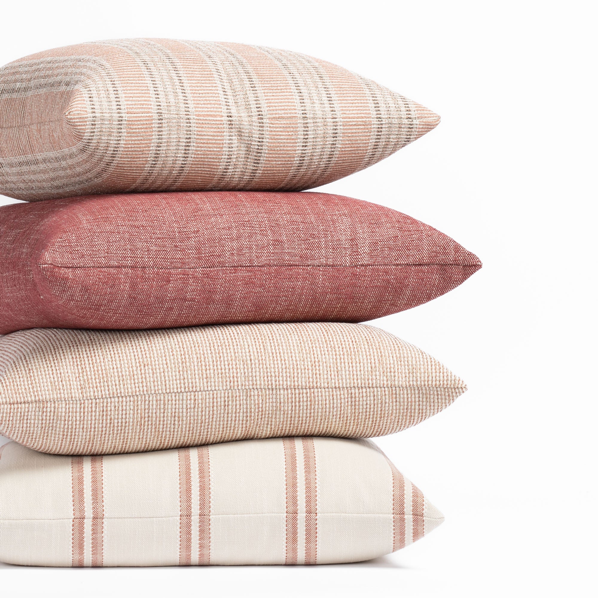 Earthy red, terracotta clay and sandy taupe outdoor pillow collection from Tonic Living