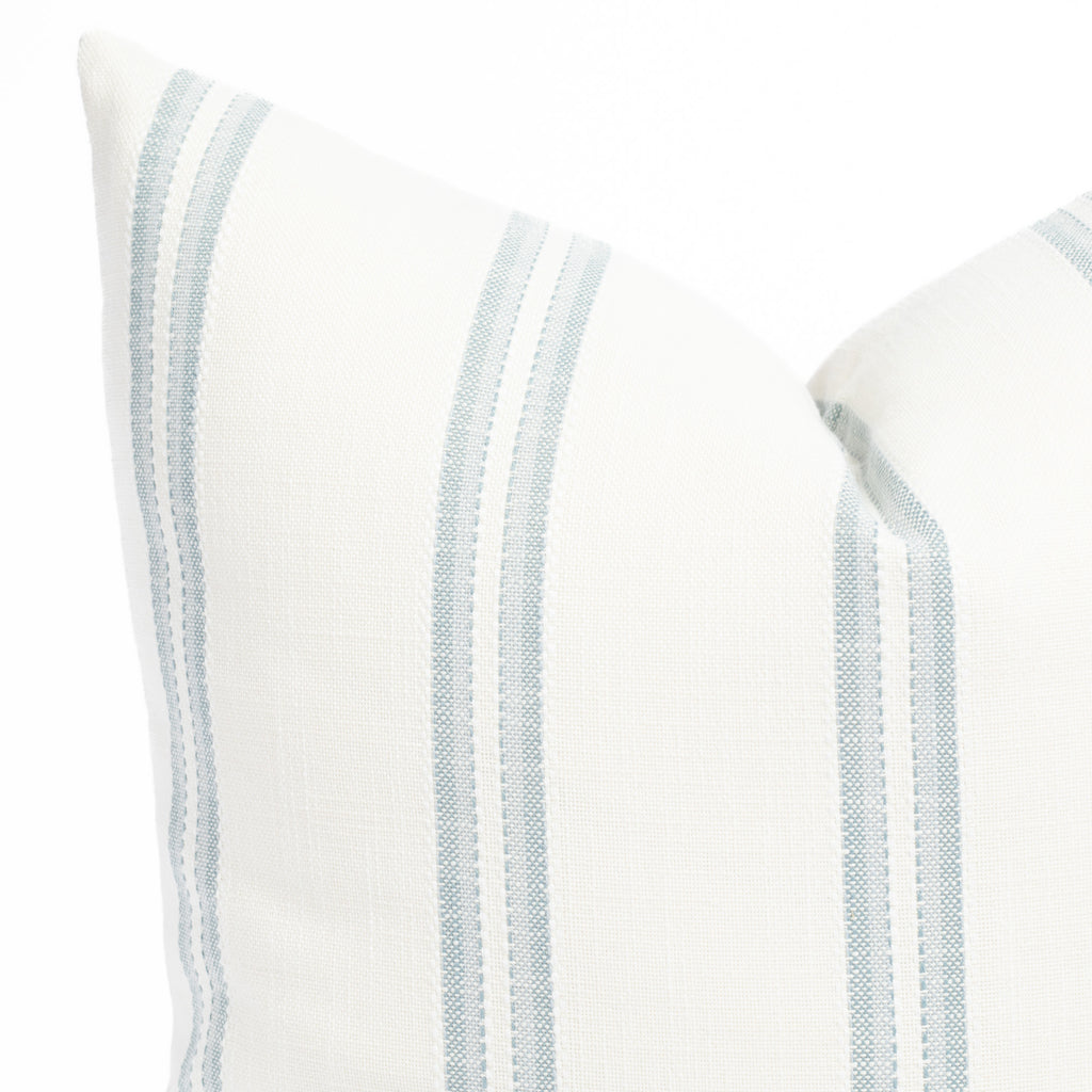 a white and chambray blue striped outdoor throw pillow : close up view