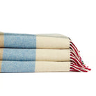 Stack of folded Tonic Living Rowan Check wool throw blankets in Orchard featuring colourful oversized checks and fringed edges.