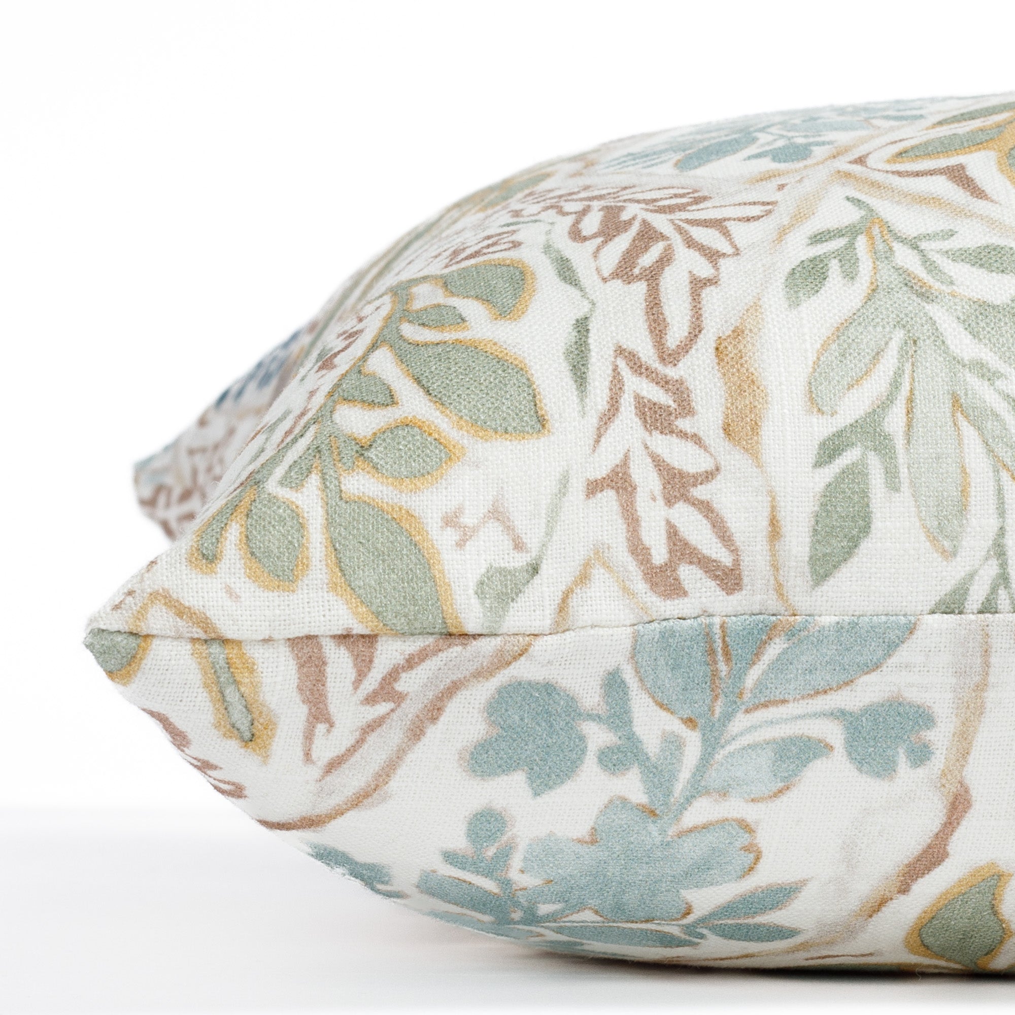 a multicoloured floral garden print throw pillow : close up side view