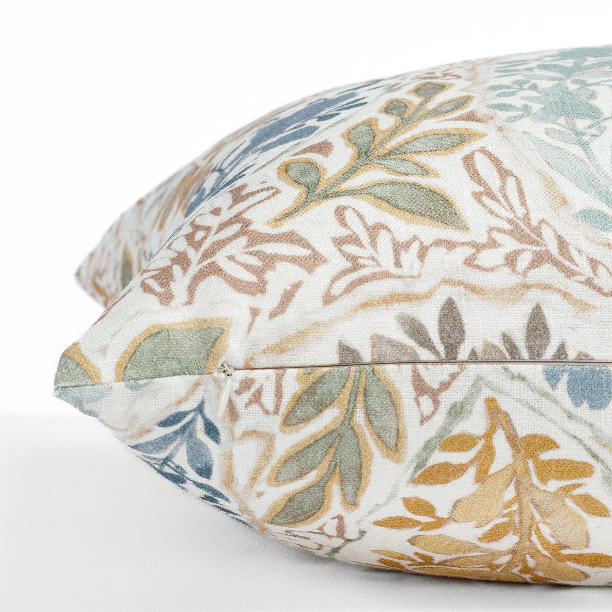a multicoloured floral garden print throw pillow : close up zipper view