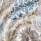 an aqua, sage, marigold, mauve and stone blue watery floral print fabric : close up