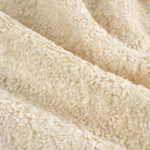 Close up of Tonic Living Rupert Parchment upholstery fabric showing its creamy bouclé weave and dimensional texture.