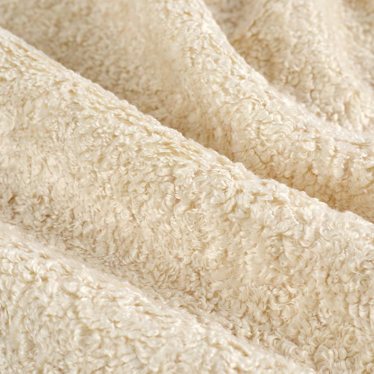 Close up of Tonic Living Rupert Parchment upholstery fabric showing its creamy bouclé weave and dimensional texture.