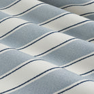 Tonic Living Sentiment Sunbrella Denim performance fabric showing movement in a bold blue striped design.