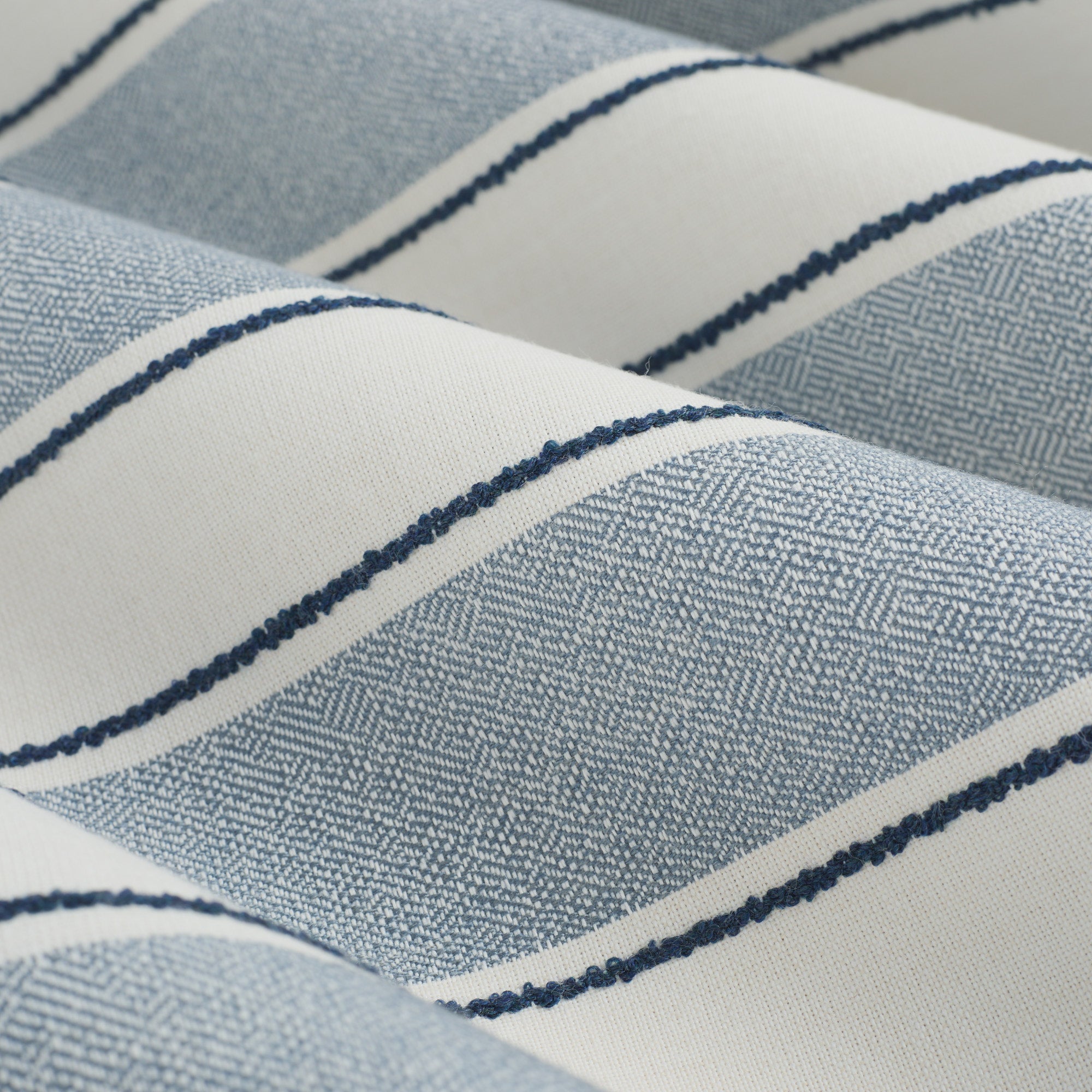 Close up of Tonic Living Sentiment Sunbrella Denim fabric showing white, denim blue, and navy stripe detail.