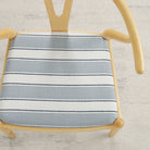 Tonic Living Sentiment Sunbrella Denim indoor/outdoor upholstery fabric on a dining chair seat in blue and white stripe.