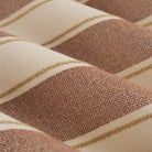 Close up of Tonic Living Sentiment Sunbrella Terracotta fabric showing terracotta, sand, and beige stripe detail.