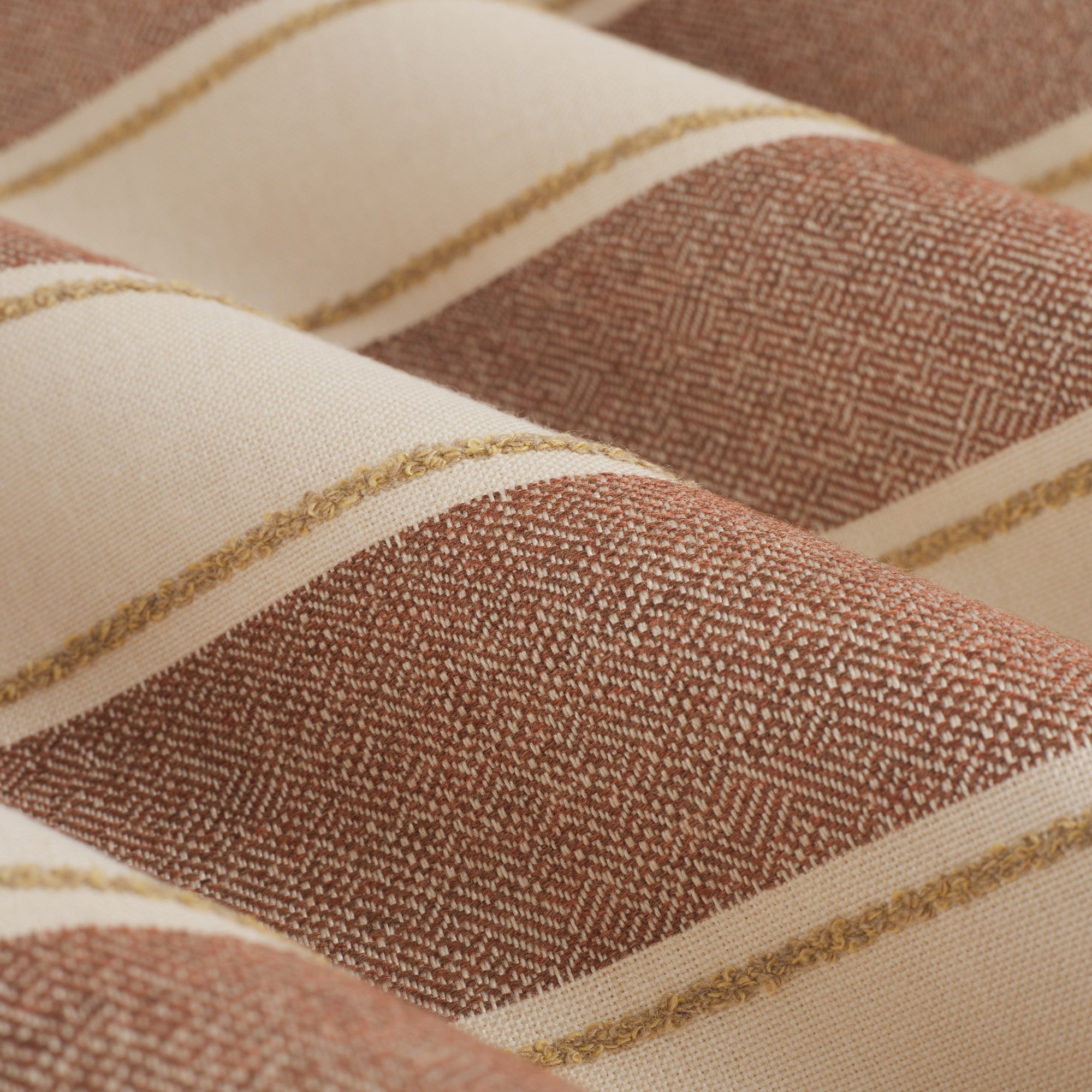 Close up of Tonic Living Sentiment Sunbrella Terracotta fabric showing terracotta, sand, and beige stripe detail.