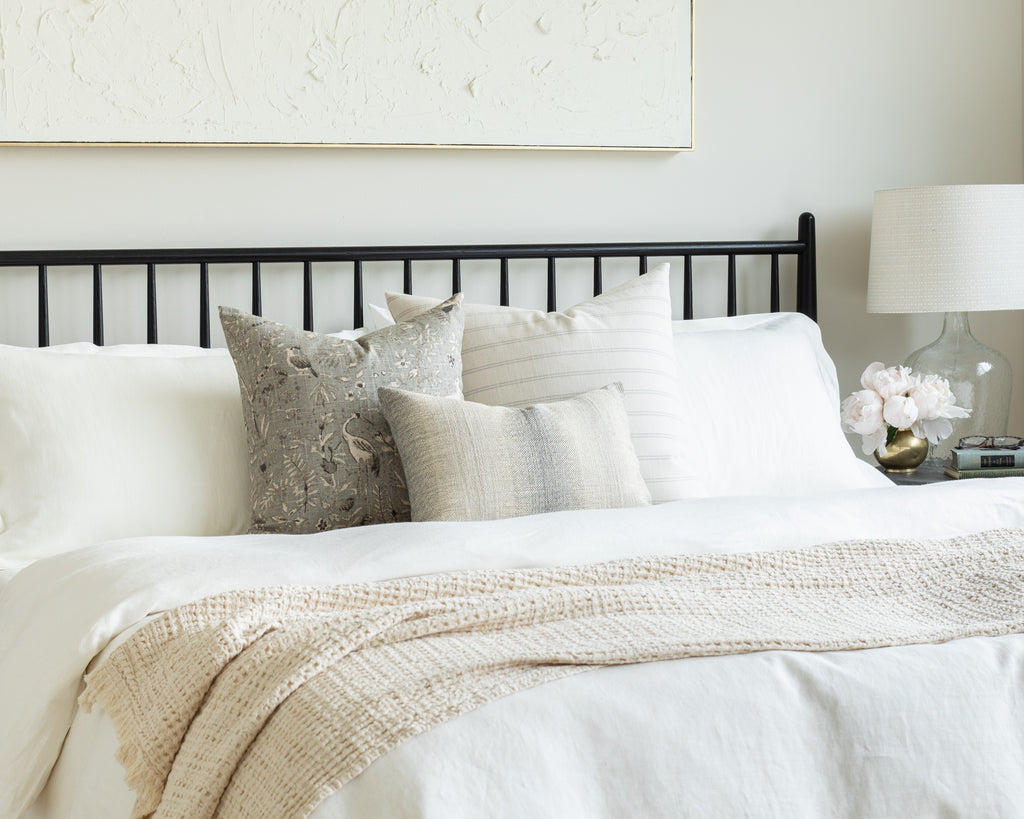 Cream and Smokey Blue Bed Pillow Pairing: a cream and smokey blue bedscape mixing a simple horizontal stripe with a vintage botanical print and ombré lumbar
