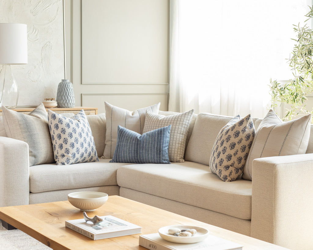 Indigo and cream sectional pillow pairing: a group of seven throw pillows bringing together a variety of organic stripe patterns with a block print floral