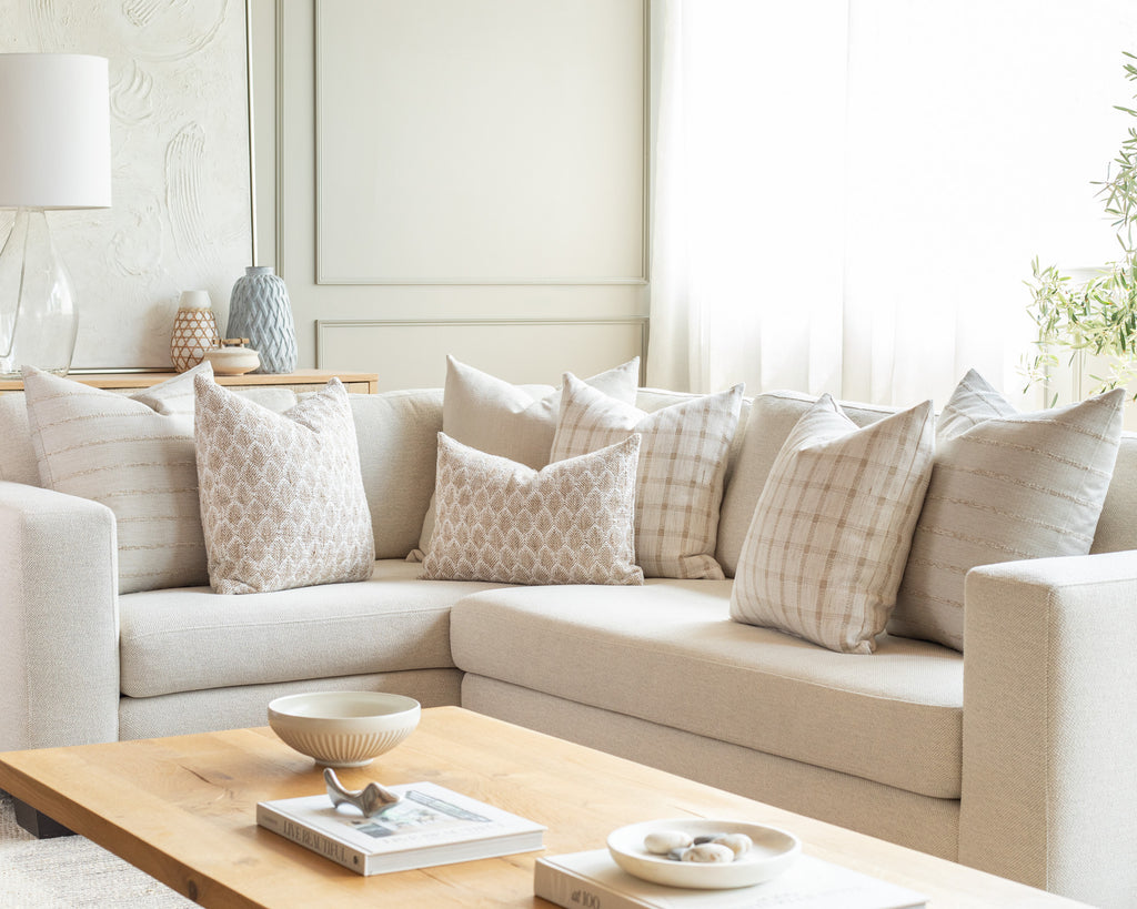 light earthy naturals sectional pillow pairing: a combination of cream and greige pillows in a variety stripe, check and small scale wheat patterns