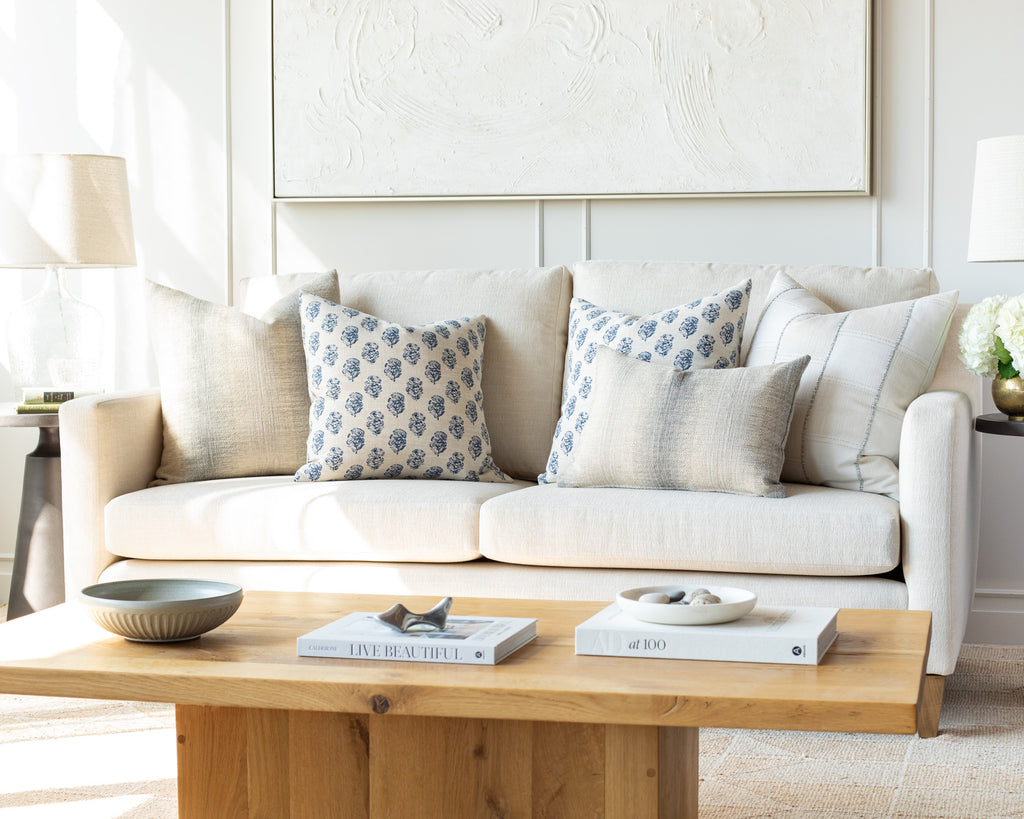 Indigo and cream sofa pillow pairing: a combination of cream and indigo blue pillows mixing organic stripes and a floral block print pattern